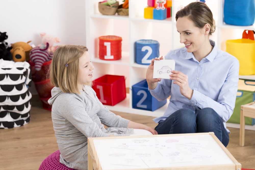 Little blonde girl visiting professional therapist